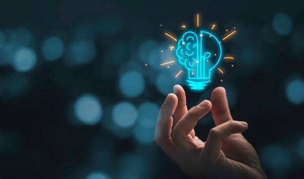 Hand holding a glowing lightbulb with a brain inside, symbolizing new ideas and career launch.