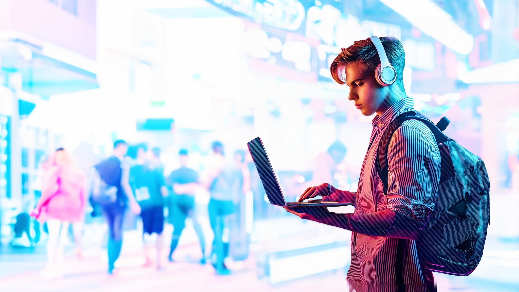 Person with headphones and laptop in a vibrant setting